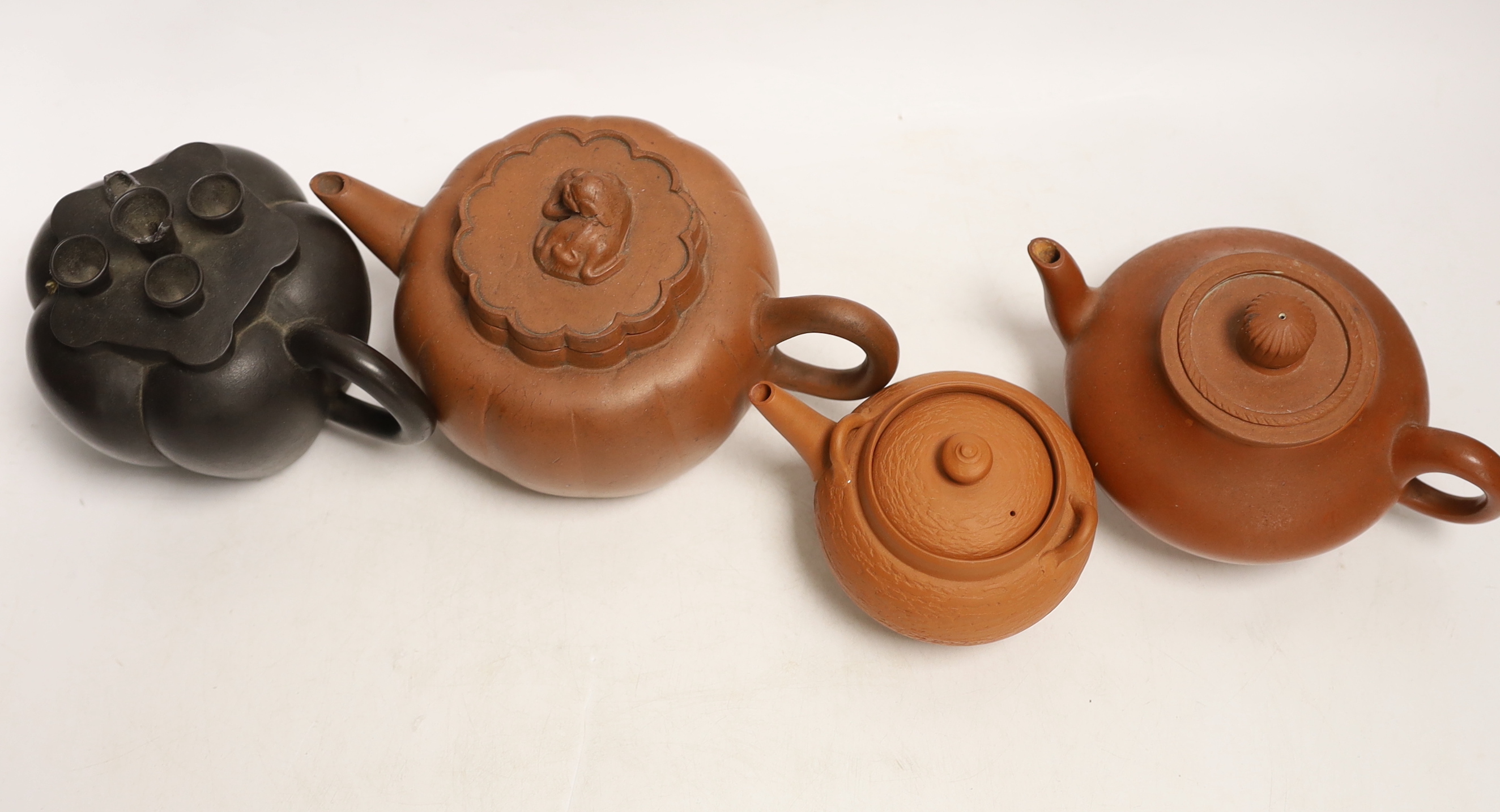 Four Chinese Yixing terracotta teapots, largest 10cm